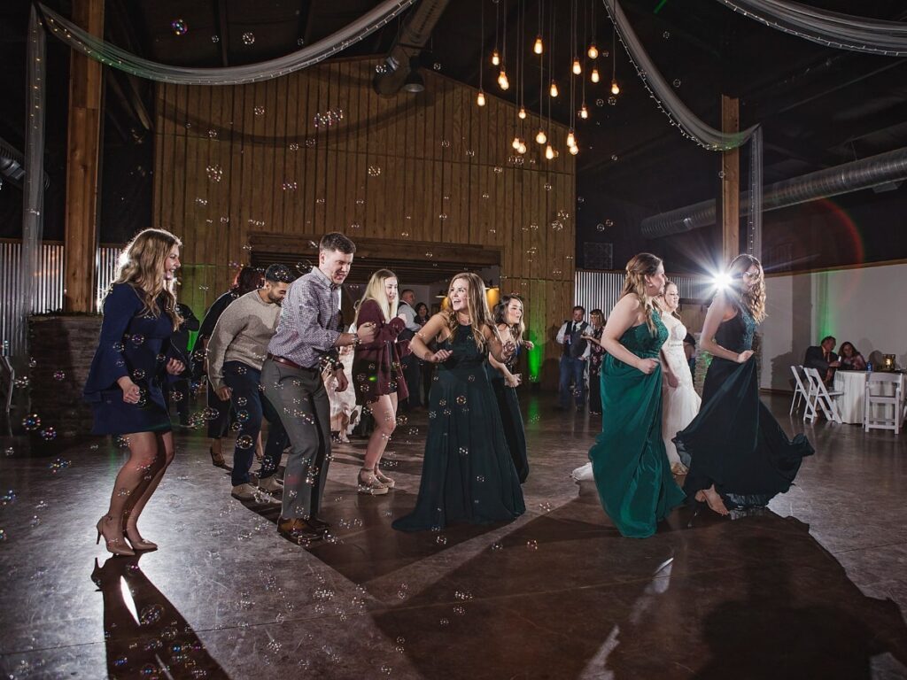 DJ playing music at a rustic barn wedding