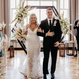 Couple entering to custom DJ playlist at wedding reception